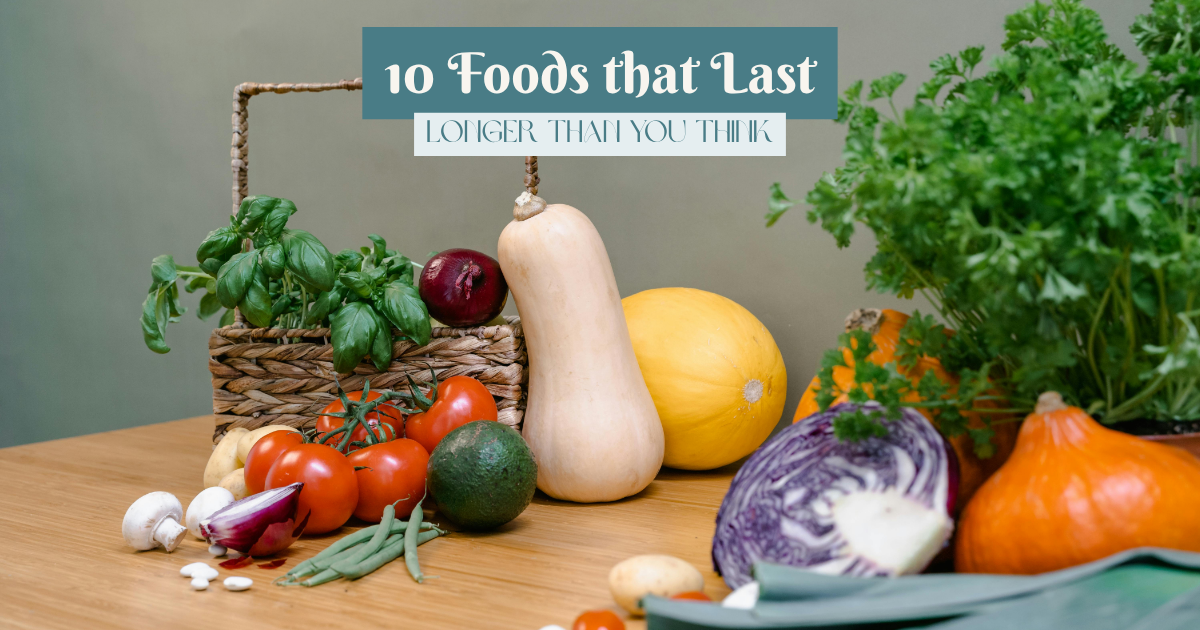 Fresh vegetables and herbs arranged on a wooden table, including tomatoes, squash, basil, cabbage, and leeks, ideal for home cooking and meal prep.